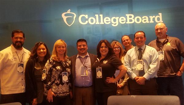 Photo of nine adults standing in front of a sign that says College Board Photo of nine adults standing in front of a sign that says College Board